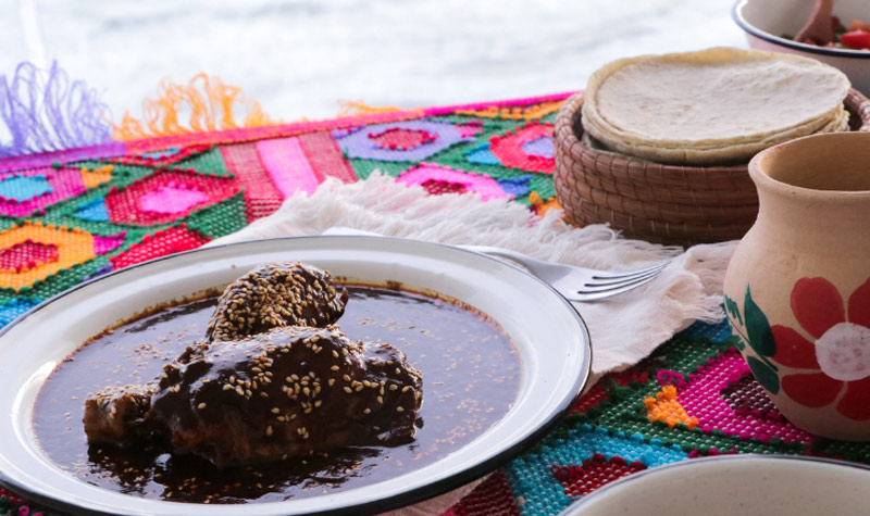 Chicken mole with corn tortillas - Mole sauce is a rich, complexly flavored sauce. Older kids and younger kids may have fun putting all the ingredients together to blend into this flavorful sauce. A meal of mole chicken would be a very authentic meal to end your Mexico unit. 
