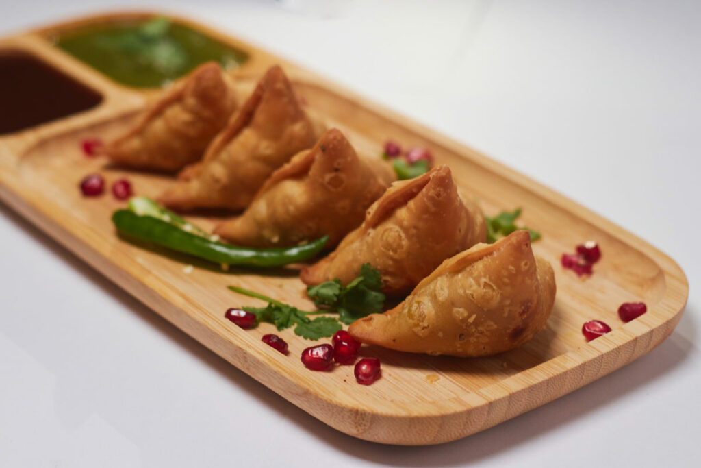 Indian samosa with chaat dipping sauce -  Crunchy and full of flavor! Try making samosa and dipping sauce to highlight your India unit at school. 