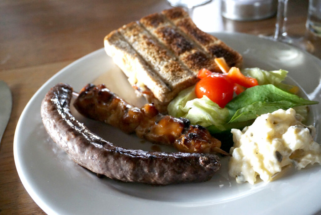 South African braai dinner - boerewors (sausage), braaibroodjie (grilled cheese), and sosatie (skewer)  - learning about South Africa for kids