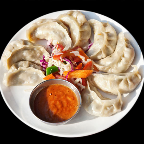 Momo with chutney - food in Nepal for kids