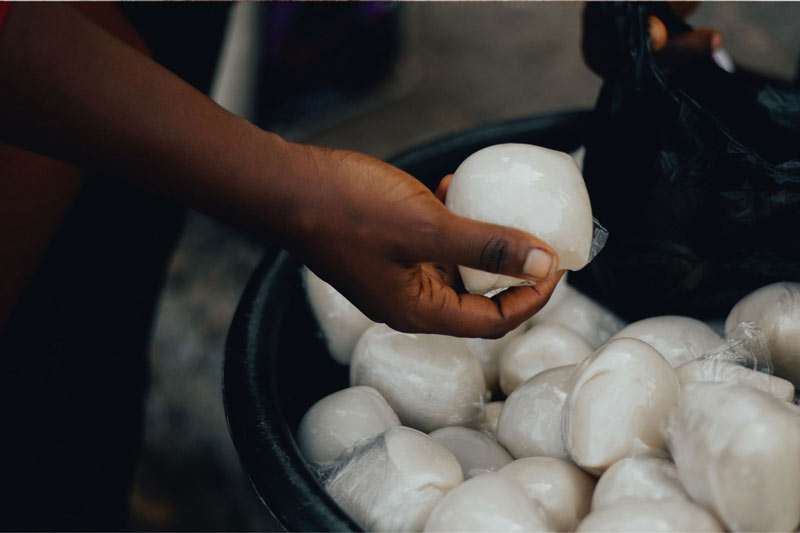 Buying Nigerian fufu from a street vendor - Image from Canva.com - Nigerian food and culture